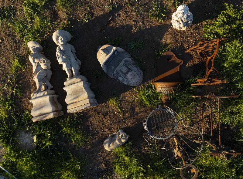 Statues are seen in an aerial of the remnants of Doran's home.