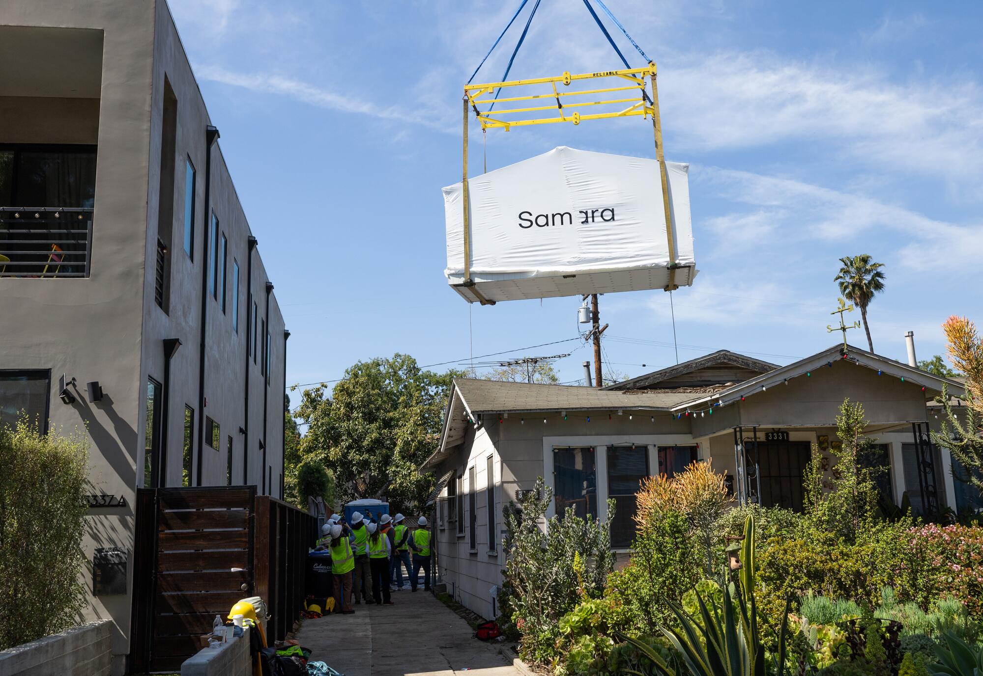 A Samara XL modular house is lowered into place at a project site