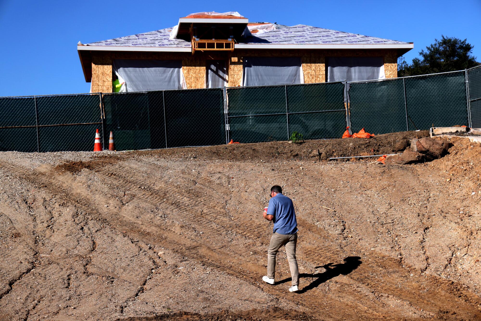 Hank Wright walks on his property where he lost his four-bedroom home in the Palisades fire.