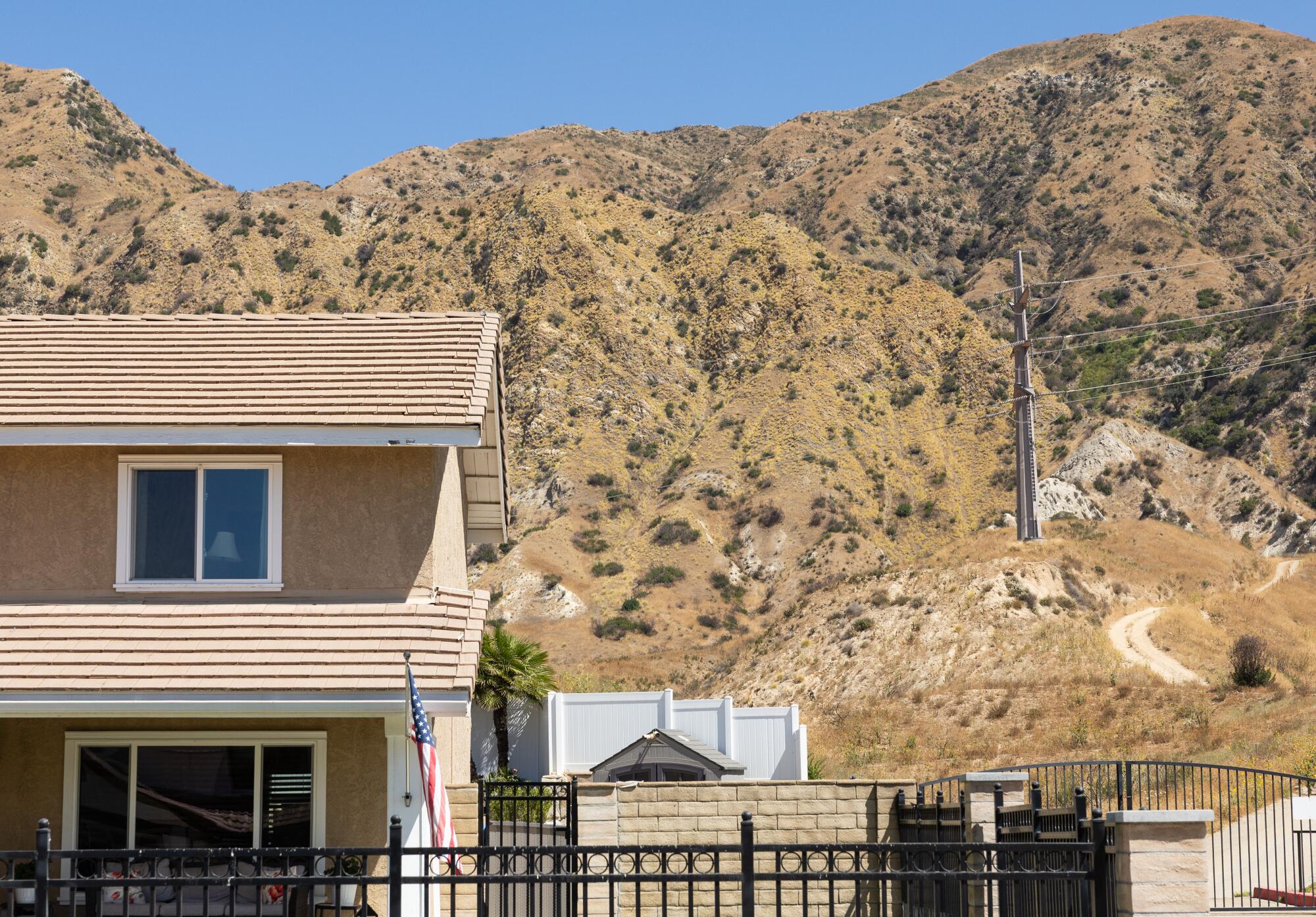 Roberto Delgado said the 2019 Saddleridge fire started at this powerline in the hillside behind his Sylmar house. 