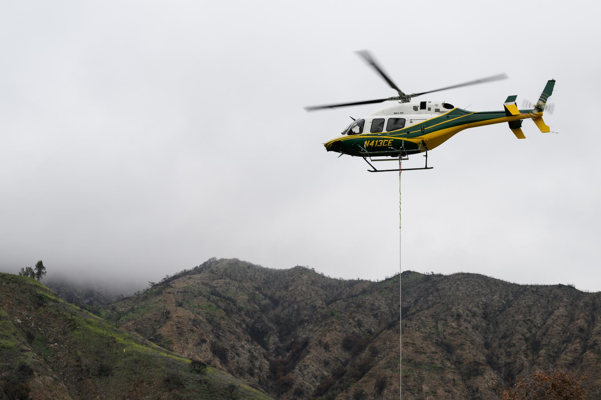 A helicopter transports workers during the process of removing Southern California Edison's tower 208