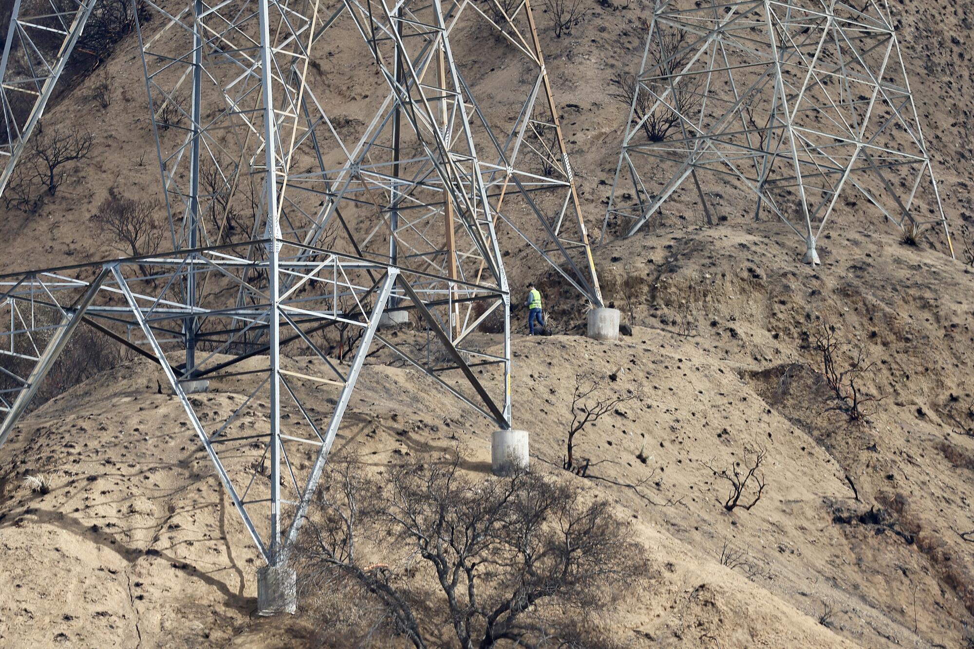 Investigators view the Edison electrical lines, transmission towers and surrounding are