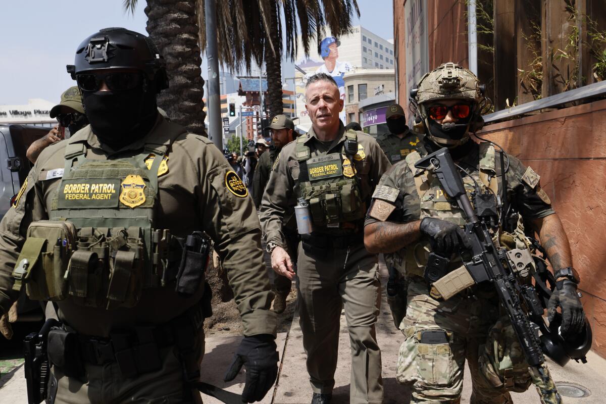 Gregory Bovino surrounded by agents