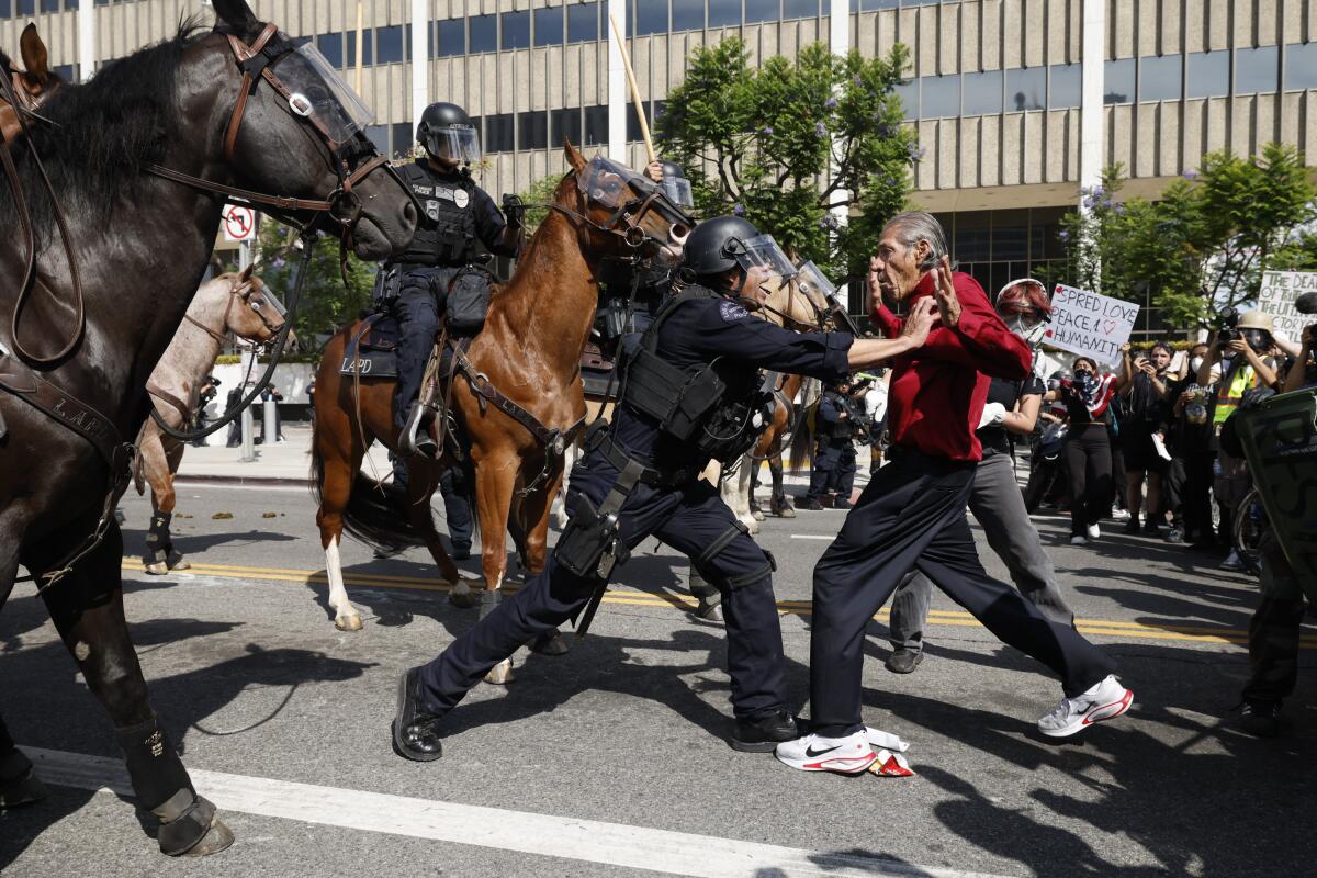LAPD officer pushes back an anti-ICE protester 