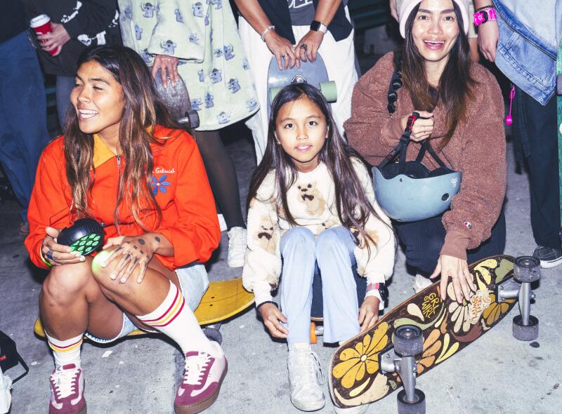 From center, Naomi Folta, Yuri Saito, 10, and her mom, Yuka Okamura, gather to take a group photo for social media.