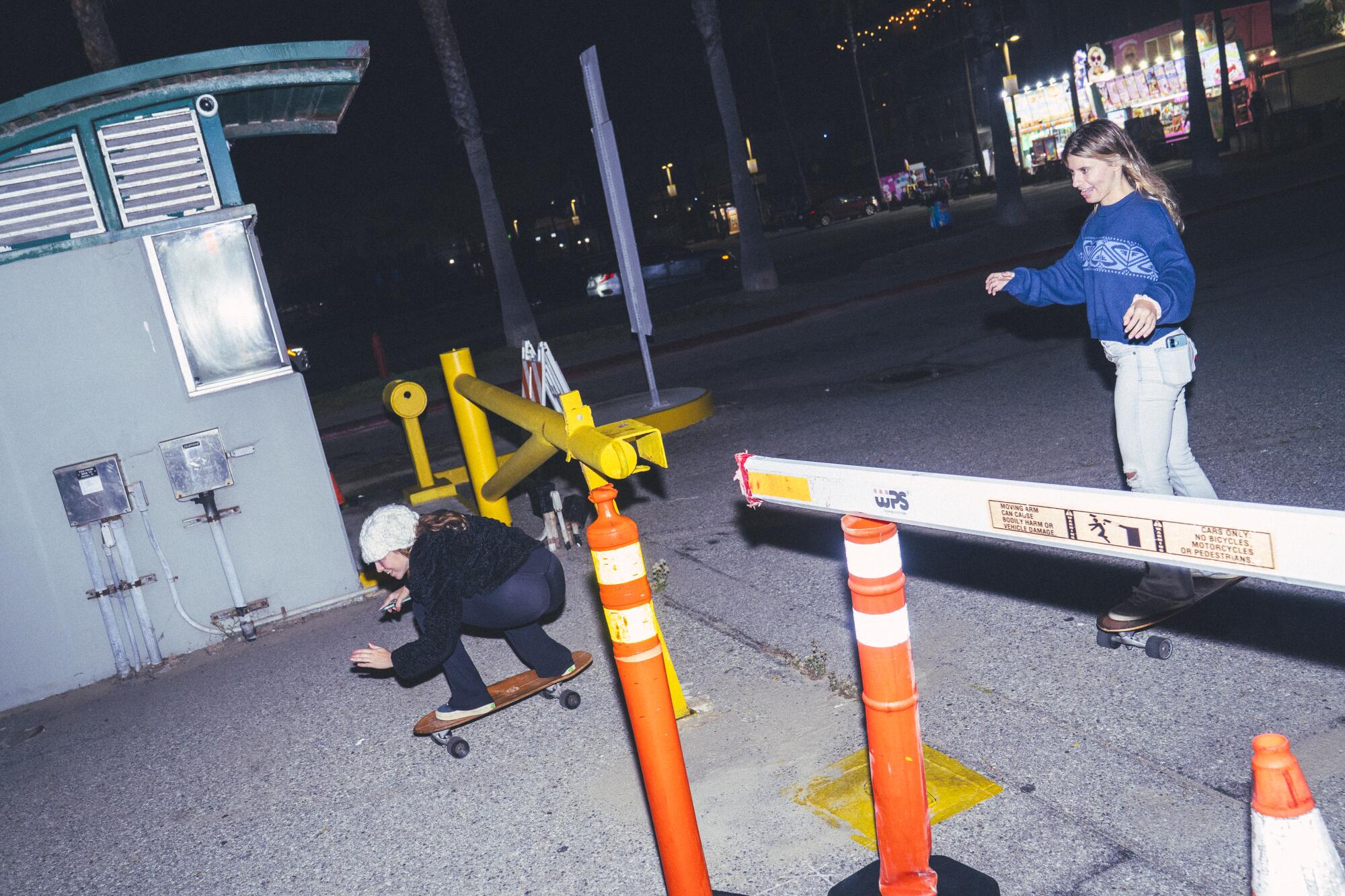 Participants dodge a parking barrier gate during a nighttime group skate.