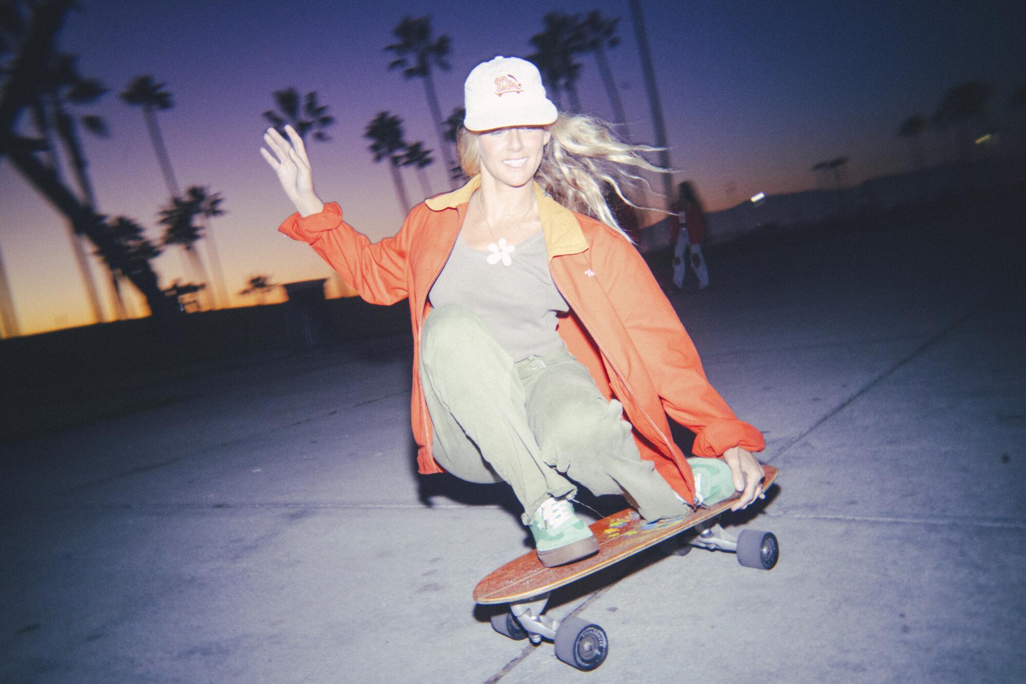 Lucy Osinski rolls in with a skateboarding move.