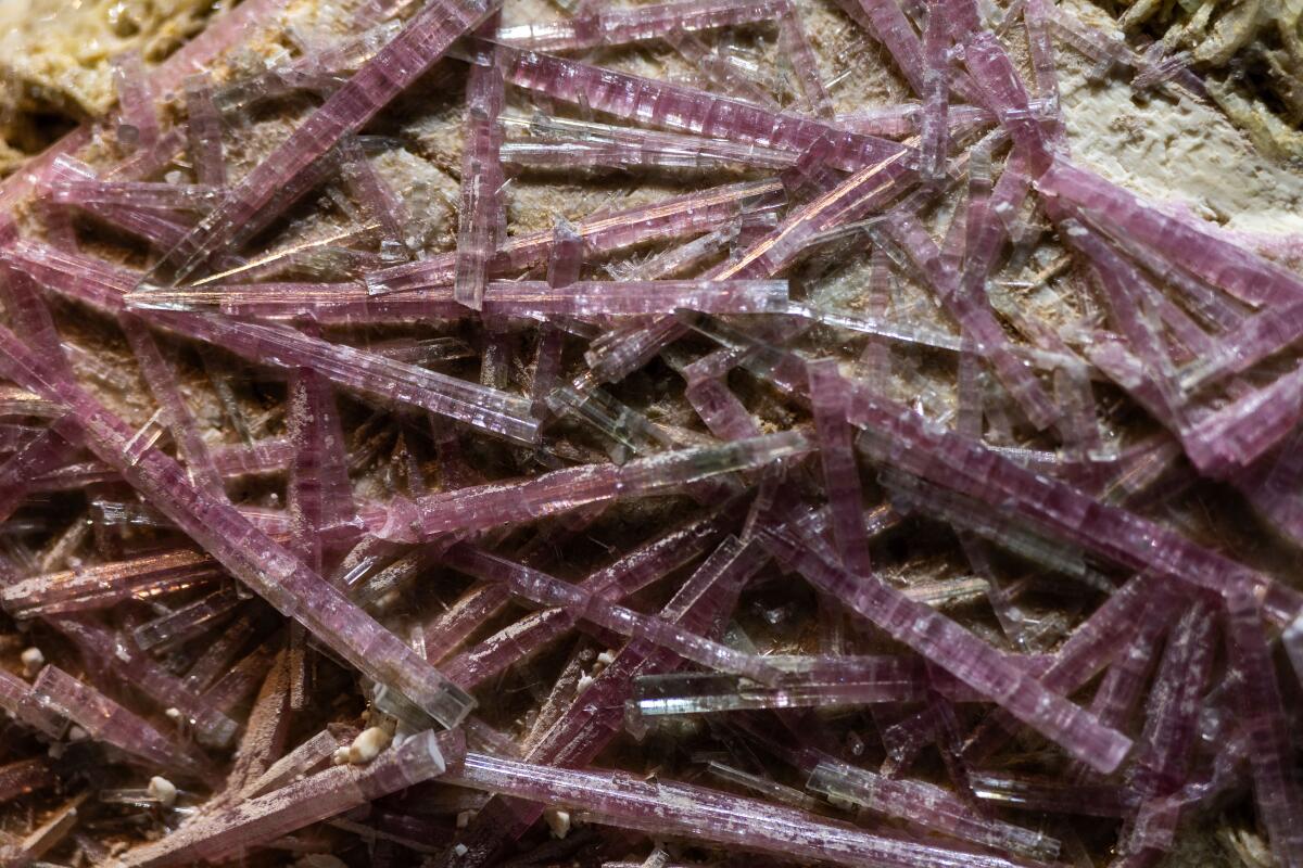 Pink crystal shards formed on top of each other.