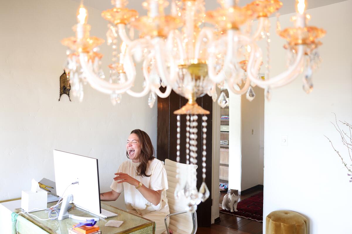 Caitlin Villarreal, her cat Zuse, and their Hollywood penthouse in the Whitley Heights.