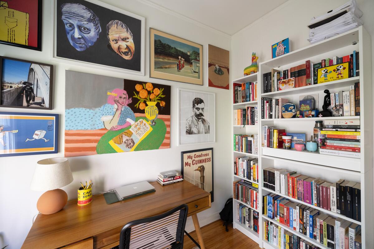 Samuel Gibson's office is decorated with artwork by a local artist, his sister and one found on the street and from eBay. He appear here seated.