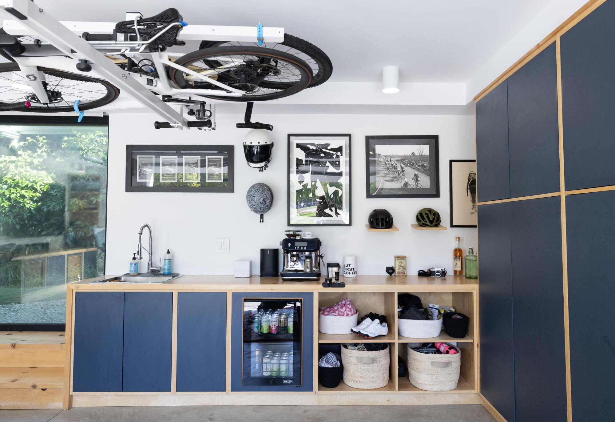 A garage with blue cabinets and espresso maker.