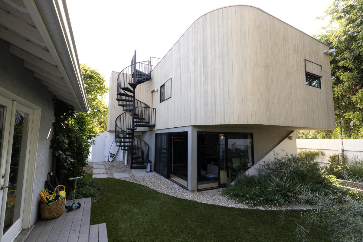 A two-story ADU from a backyard view.