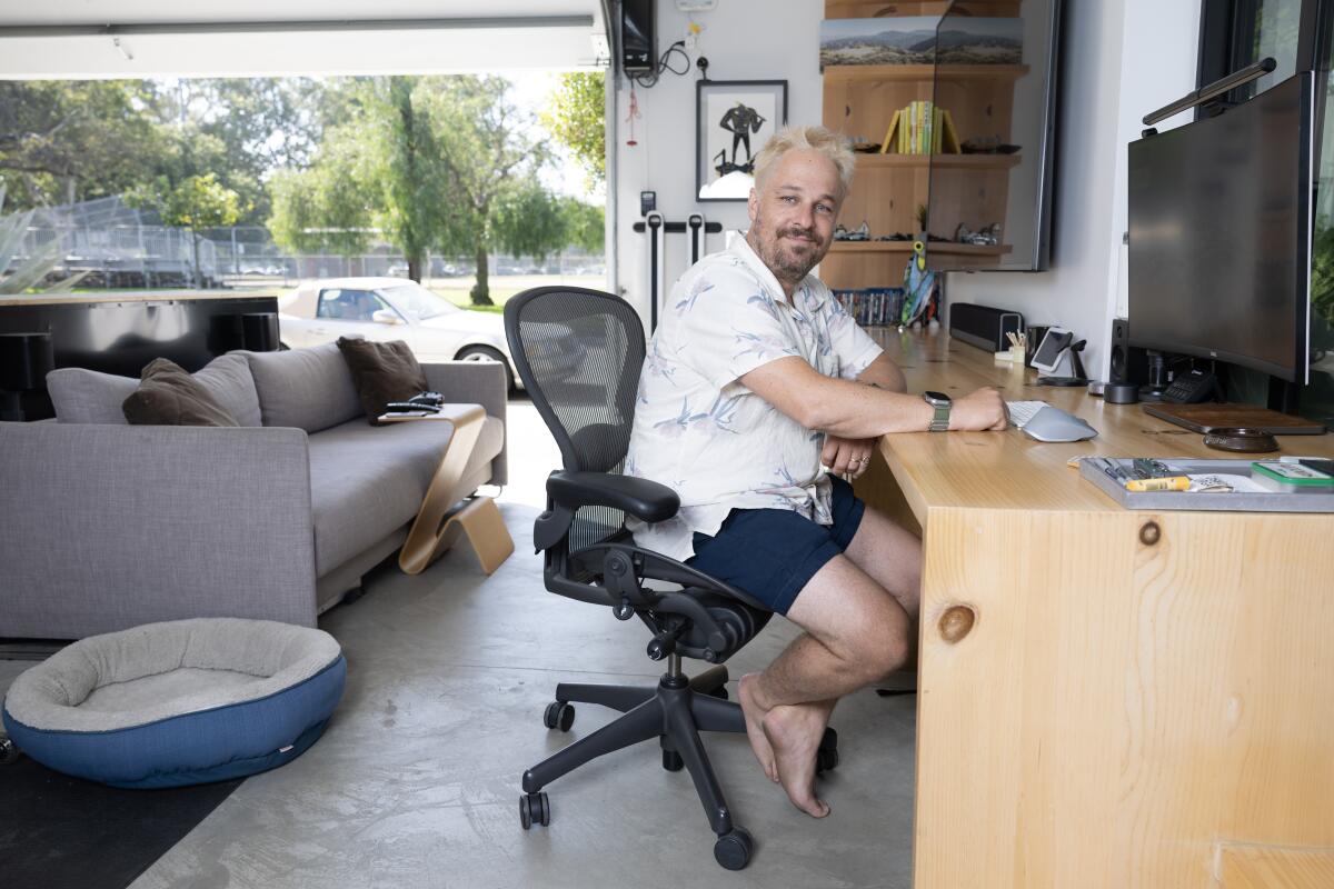 Will Burroughs sits in his downstairs garage.