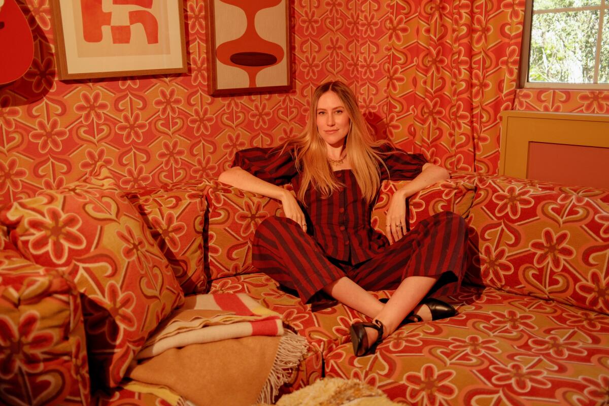 Dani Dazey sitting in her Highland Park home.