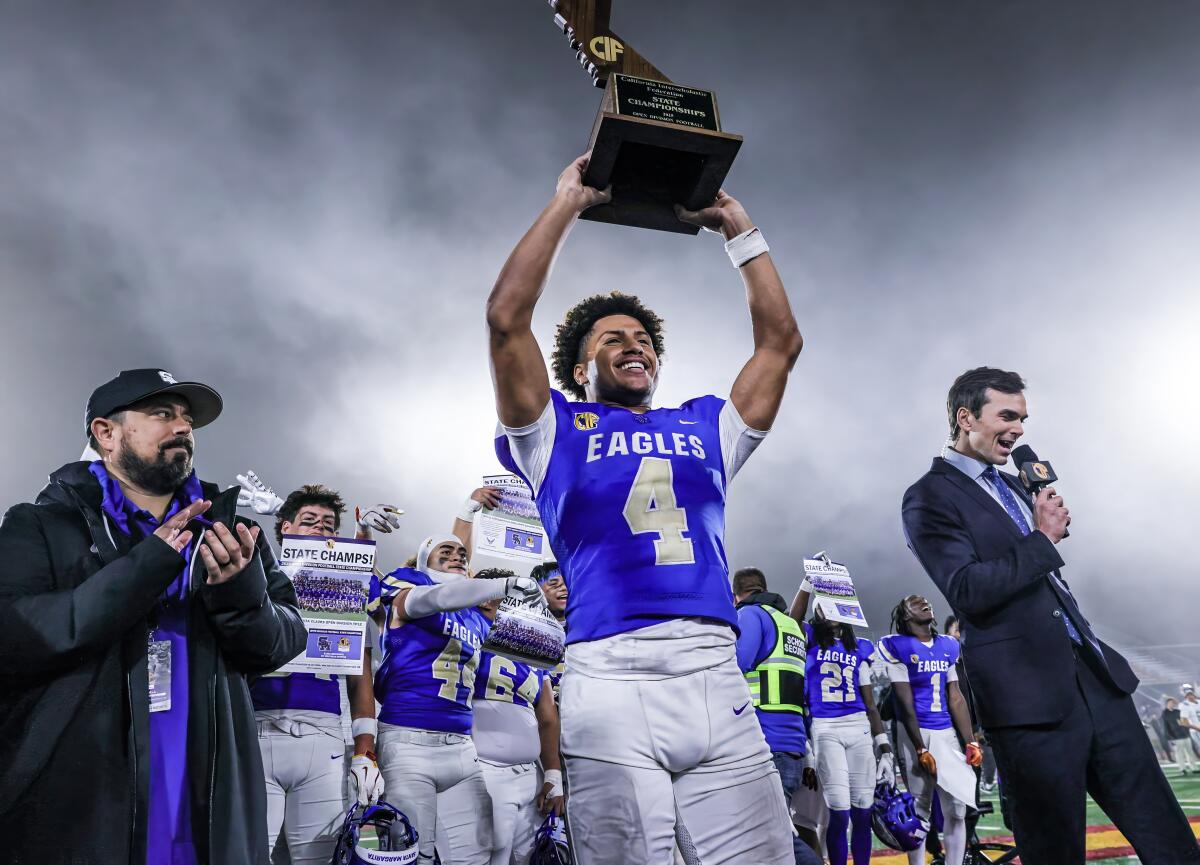 Trent Mosley of Santa Margarita holds the CIF state championship Open Division trophy after beating De La Salle.