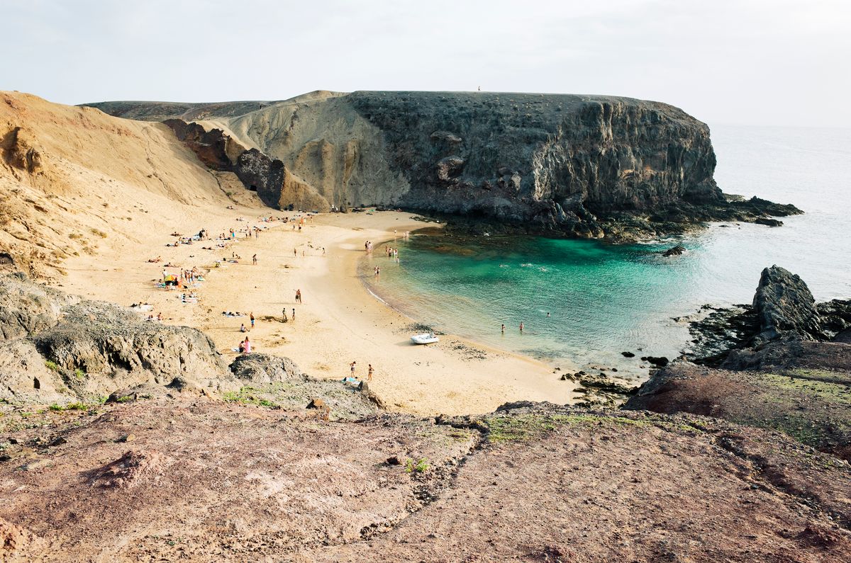 Spain, Canary Islands, Lanzarote, Playa Papagayo, elevated view over the crowded beach
