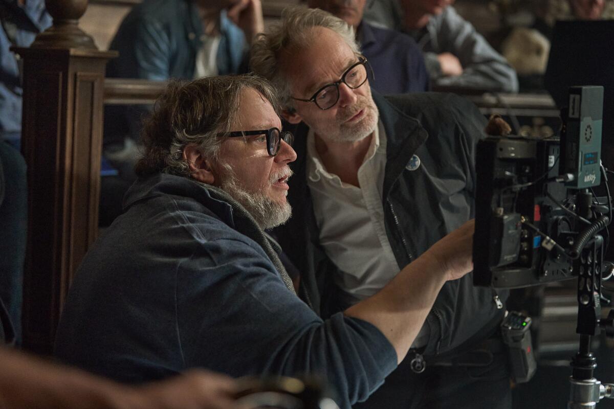 Writer/Director Guillermo del Toro and Cinematographer Dan Laustsen on the set of Frankenstein.