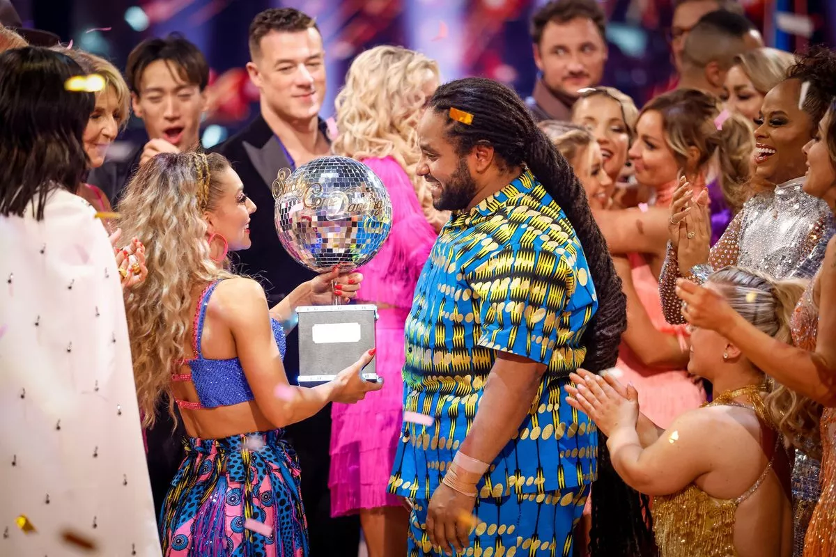 Celebratory image of Jowita Przystal  and Hamza Yassin with the Strictly Come Dancing glitterball trophy