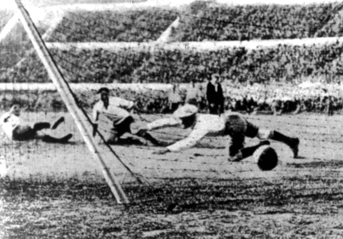 Argentina's goalkeeper (foreground) can't stop a shot by Uruguay during the 1930 World Cup final against Argentina.