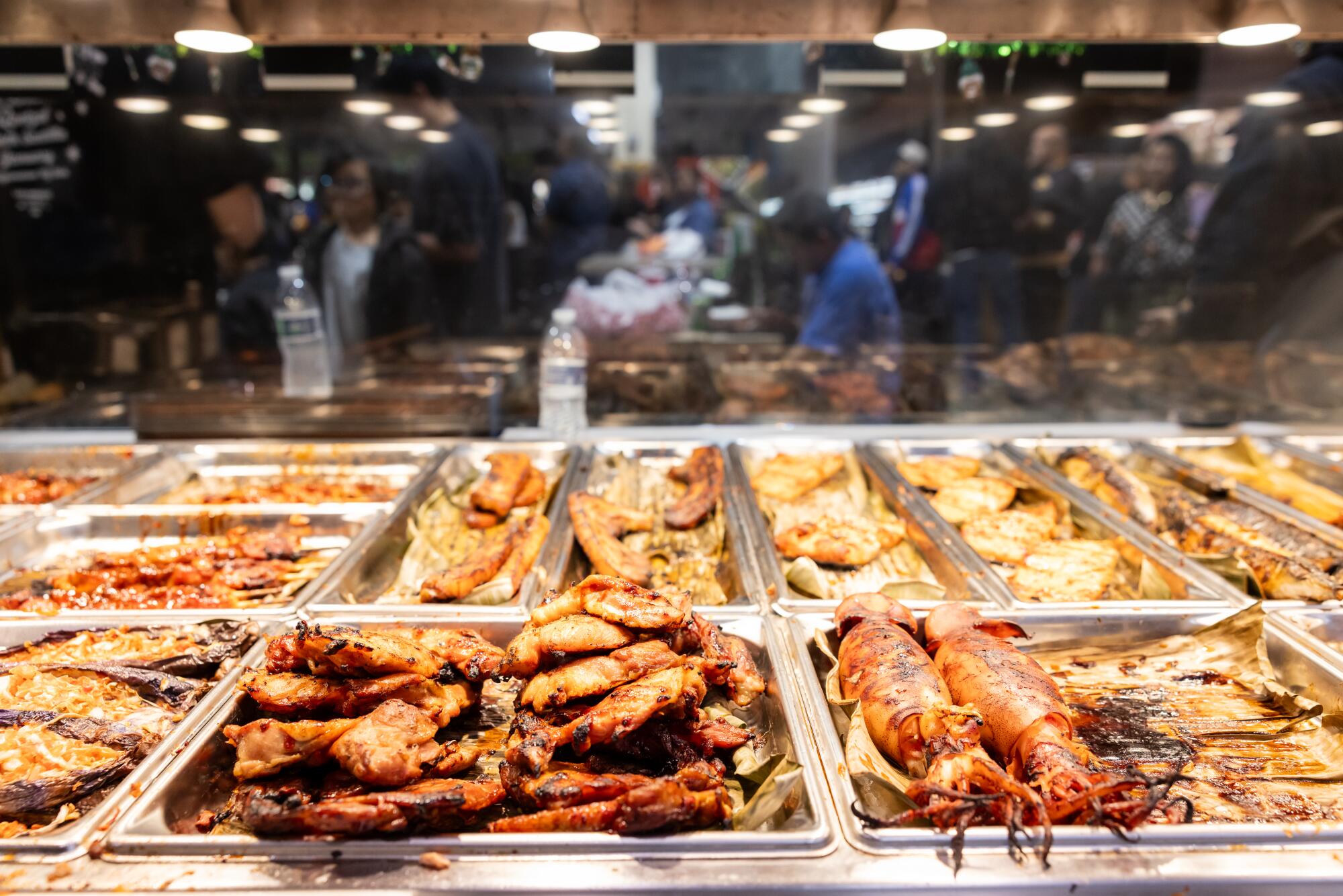 Trays of street food for sale.