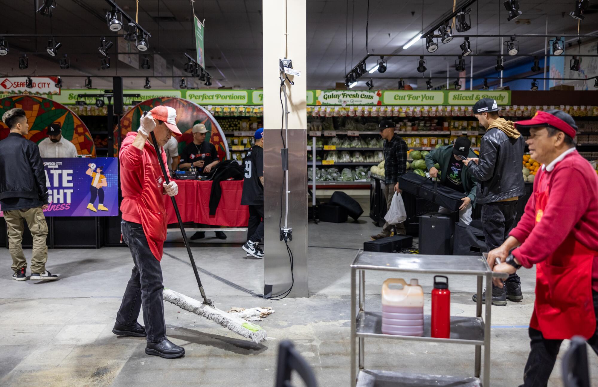 Employees clean up a grocery store.