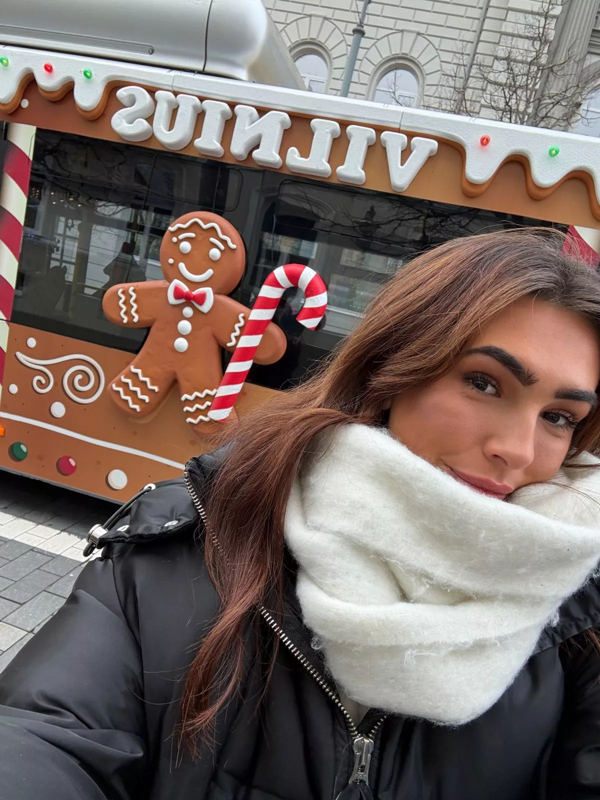 Niamh in front of a gingerbread decorated bus