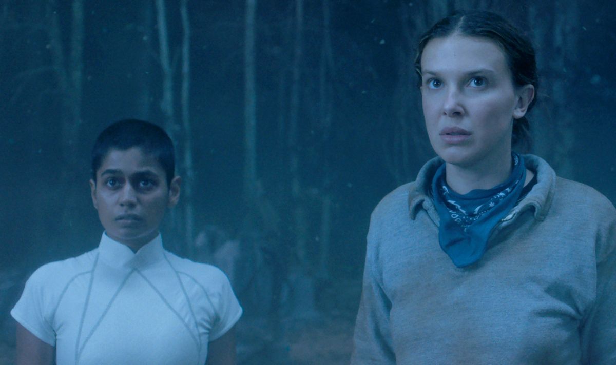 Two girls stand together and look serious 