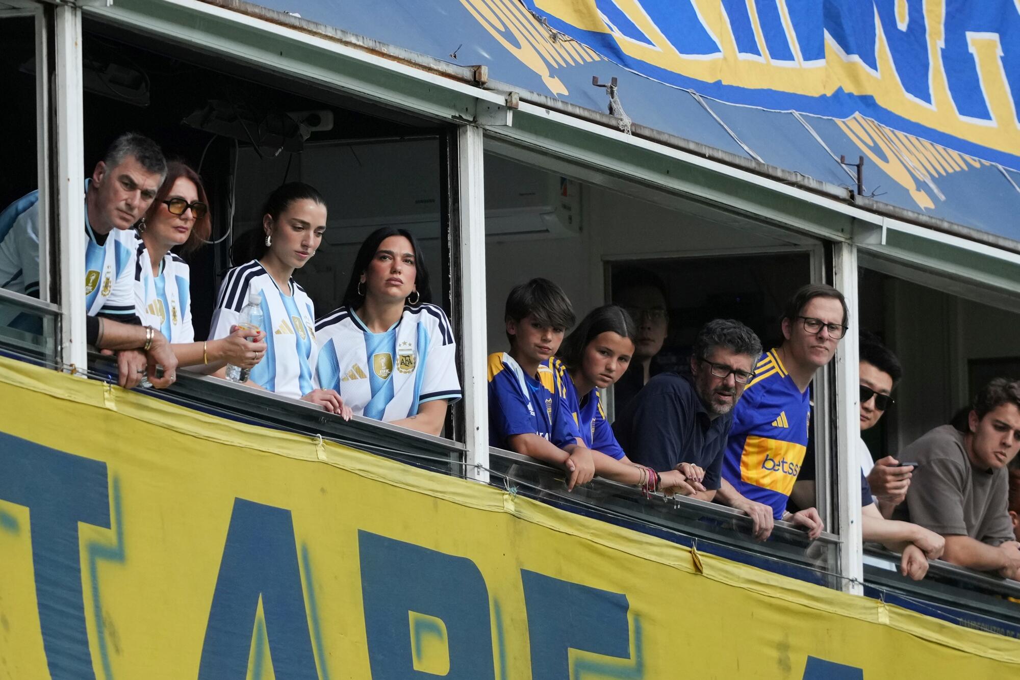 Dua Lipa, center, attends an Argentine soccer league match between Boca Juniors and River Plate in Buenos Aires Nov. 9, 2025