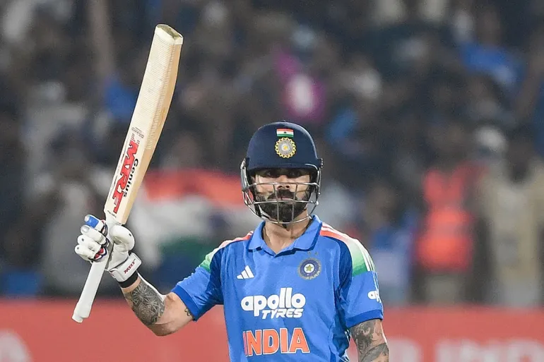 India's Virat Kohli celebrates after scoring a half-century (50 runs) during the third one-day international (ODI) cricket match between India and South Africa at the Y.S. Rajasekhara Reddy Cricket Stadium in Visakhapatnam on December 6, 2025. (Photo by AFP) / -- IMAGE RESTRICTED TO EDITORIAL USE - STRICTLY NO COMMERCIAL USE --