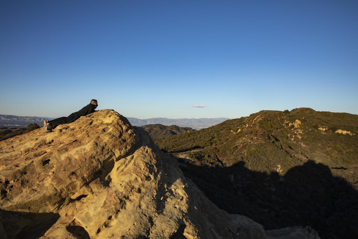 A lone hiker takes in sweeping views of the Santa Monica Mountains along the Backbone Trail in Topanga State Park.