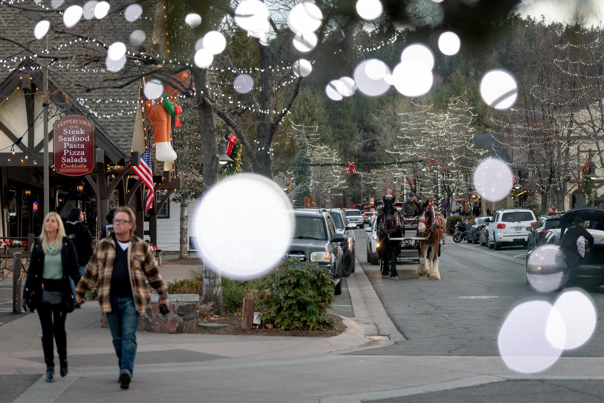 People visit Big Bear Village with no snow in sight.