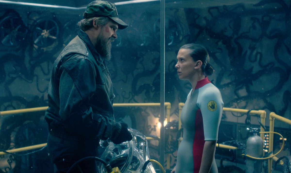 A man and a girl stand looking at each other 