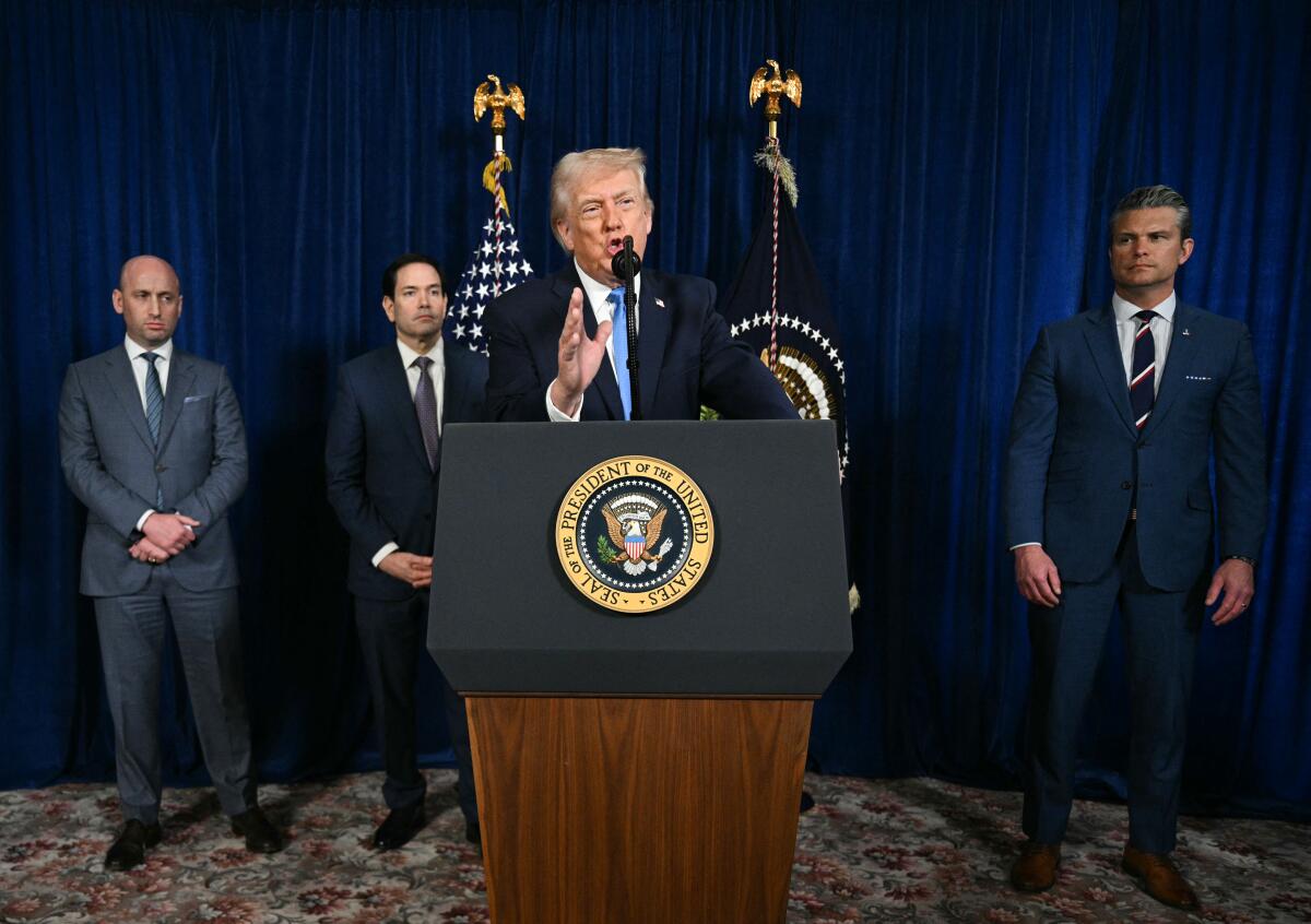 President Trump, alongside others, speaks at a lectern.