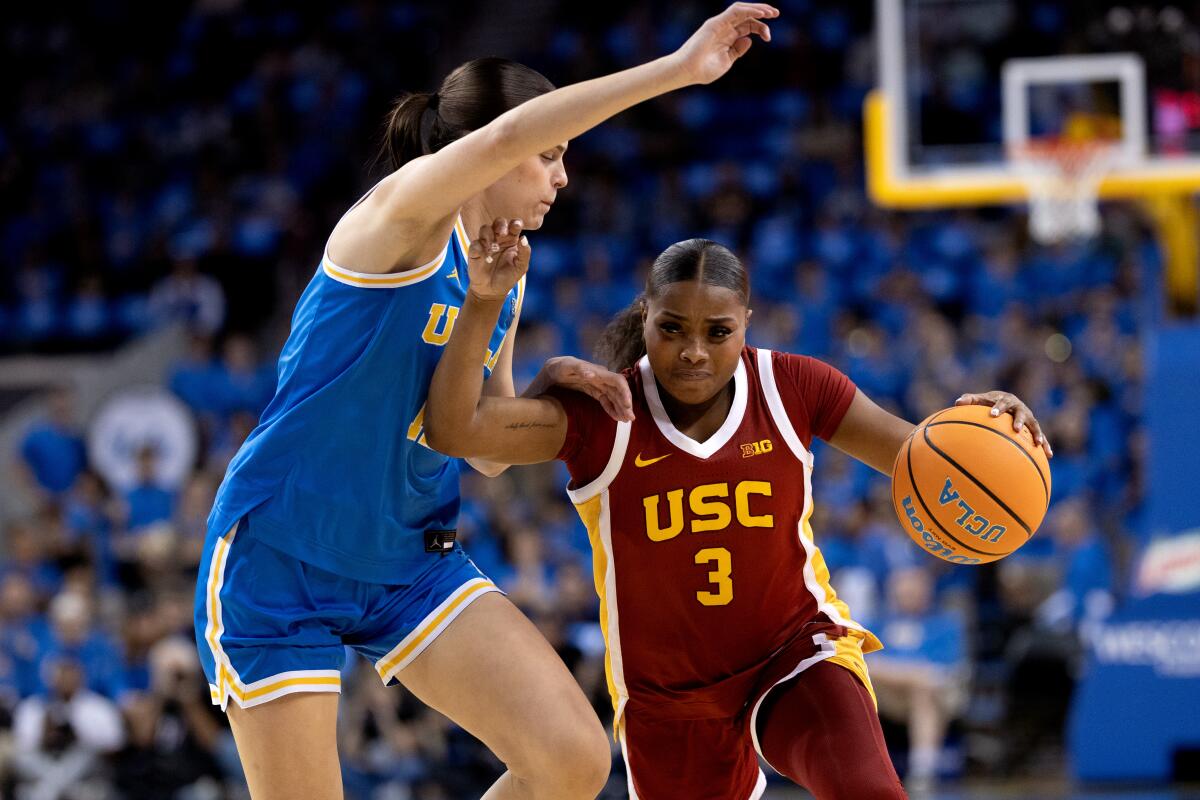 USC guard Londynn Jones, right, tries to drive past UCLA guard Gabriela Jaquez during the first half Saturday.