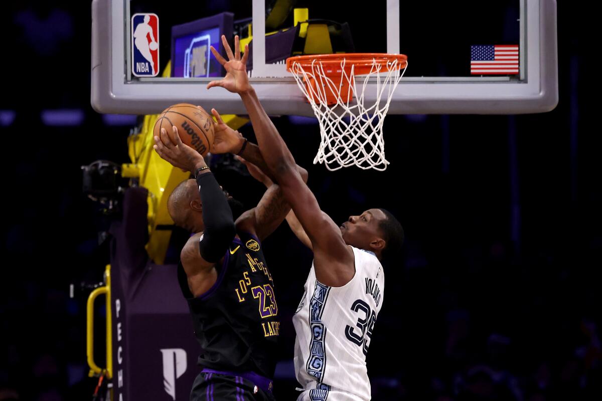 LeBron James shoots against Christian Koloko of the Grizzlies in the first quarter Sunday.