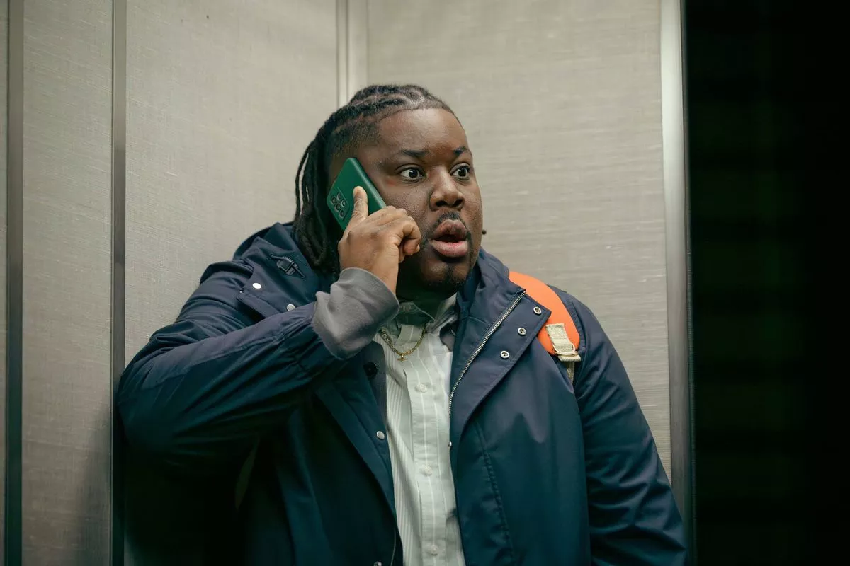 A man looking shocked on the phone