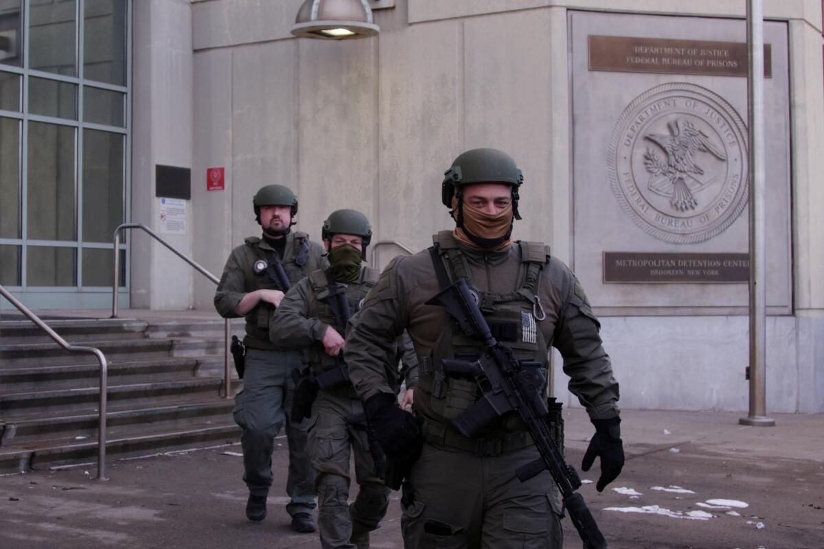 US Department of Justice federal officers stand guard outside the Metropolitan Detention Center
