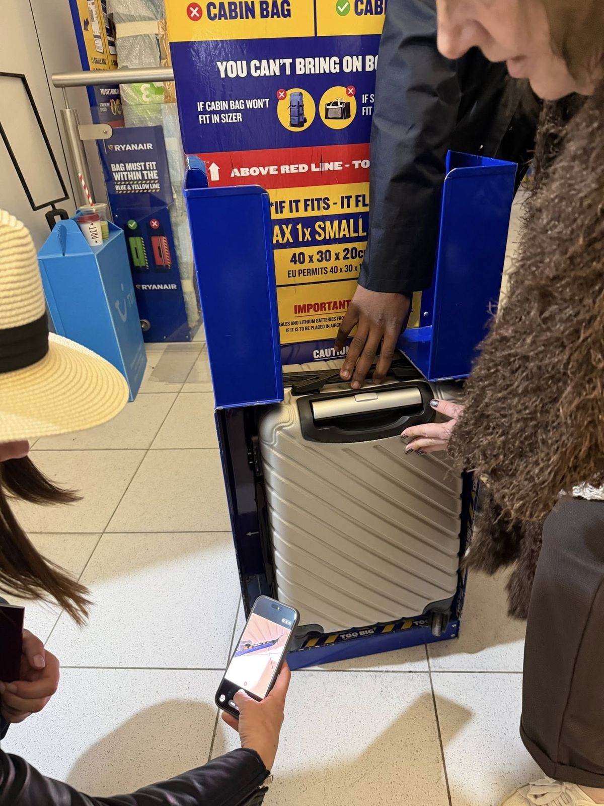 Gilly shows the bag of another woman who was fined too, despite her bag appearing to fit in the sizer.