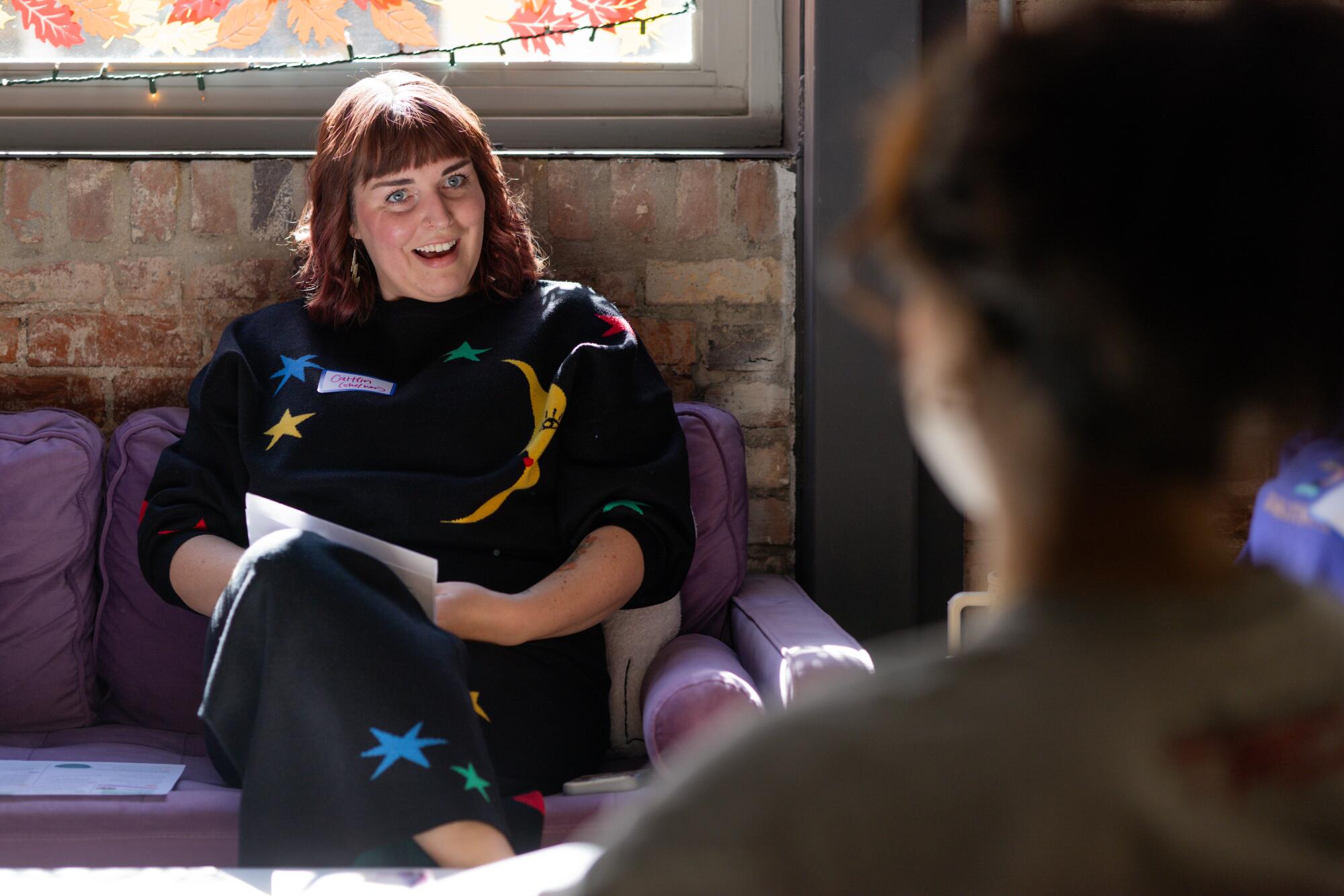 Caitlin Harrison smiles as Ella Rodriguez shares with the group.