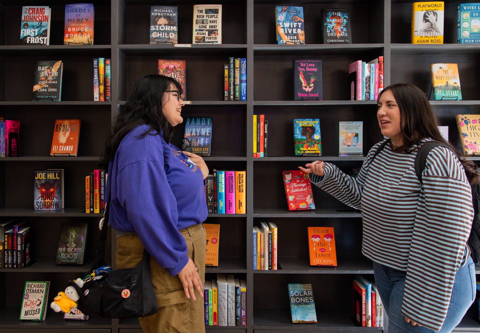 Alexa Palomo, left, and Ashley Bagwell, right, chat after their book club. 