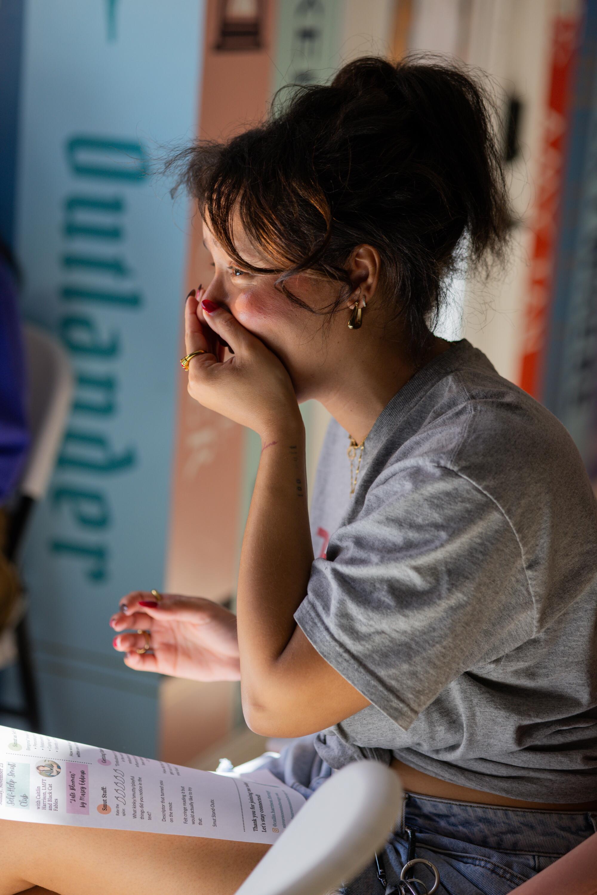 Ella Rodriguez covers her mouth and laughs as she participates in a group discussion.