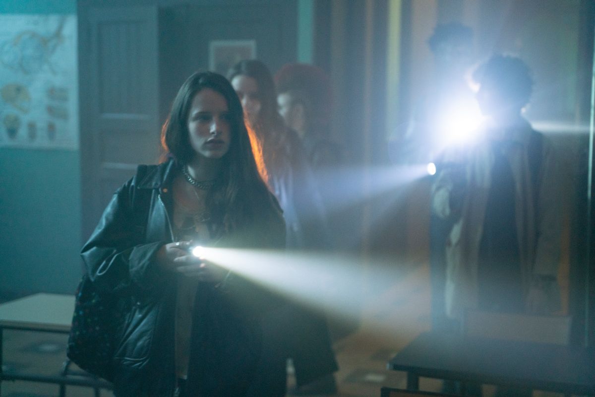 Group of teenagers holding flash lights 