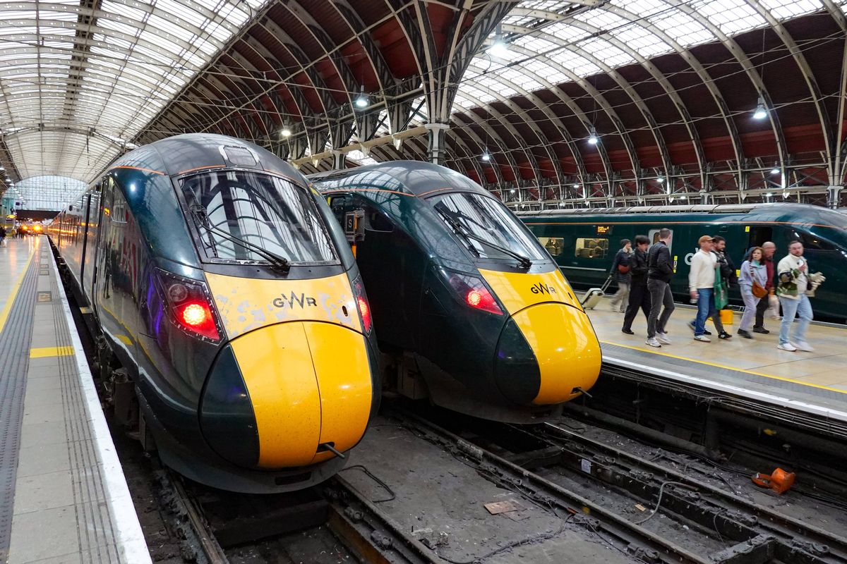 Three green Great Western Railway Intercity Express Trains stand at adjacent platforms at Paddington station while passengers walk along the station floor in London, Greater London, United Kingdom, on December 23, 2025. The station serves as the historic London terminus for the Great Western Main Line. (Photo by Michael Nguyen/NurPhoto via Getty Images)