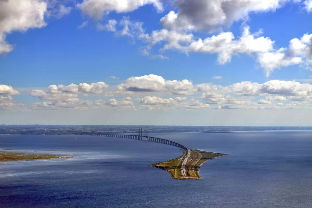 Aerial view of the Øresund Bridge on a sunny afternoon. The Øresund Bridge is a combined railway and motorway bridge across the Øresund strait between Sweden and Denmark. It is the longest combined road and rail bridge in Europe,