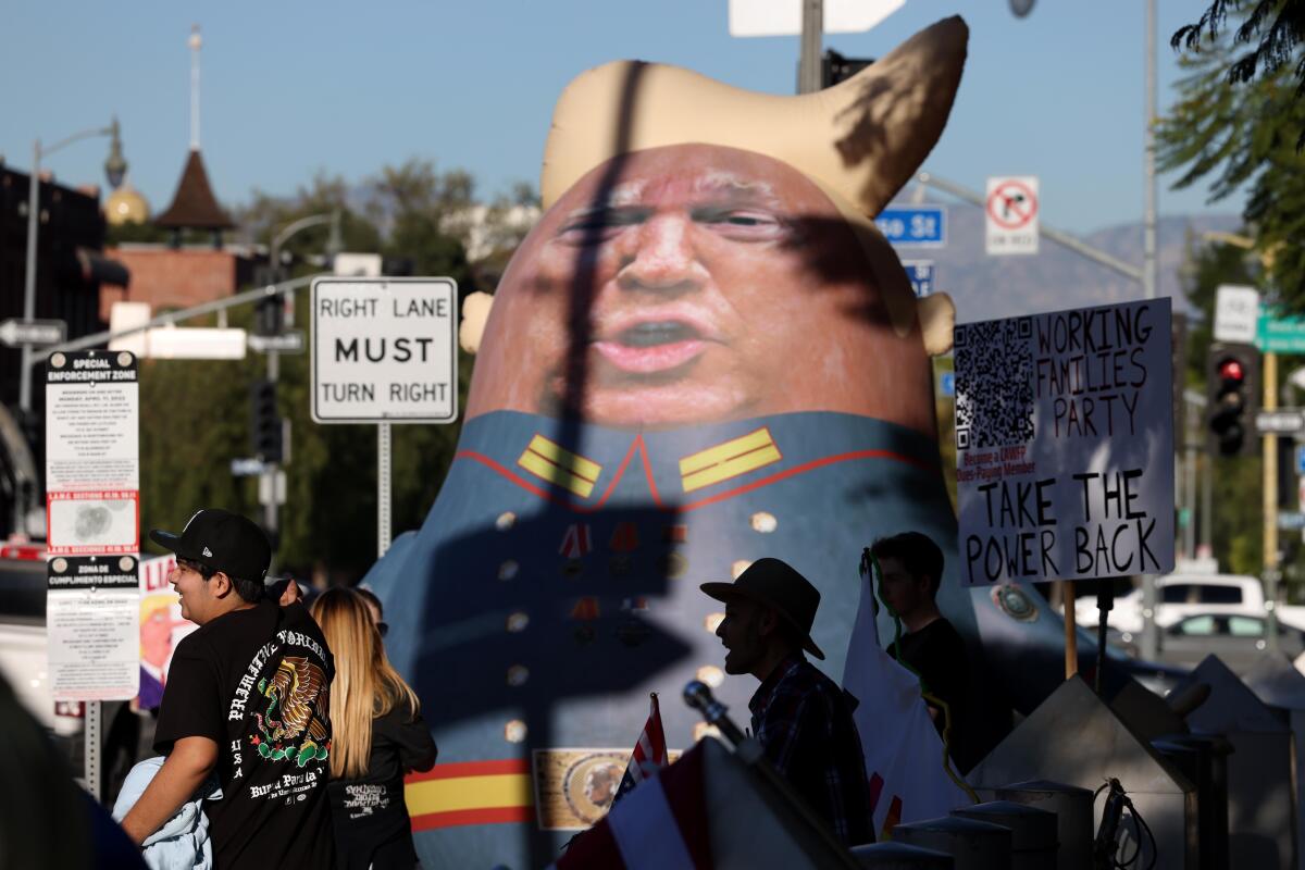 an inflatable doll of Trump in a Russian military outfit
