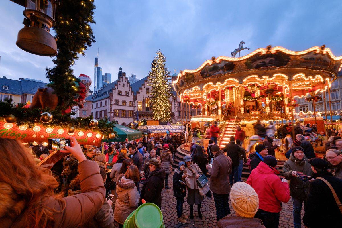 Visitors walk among stalls at a Christmas market 
