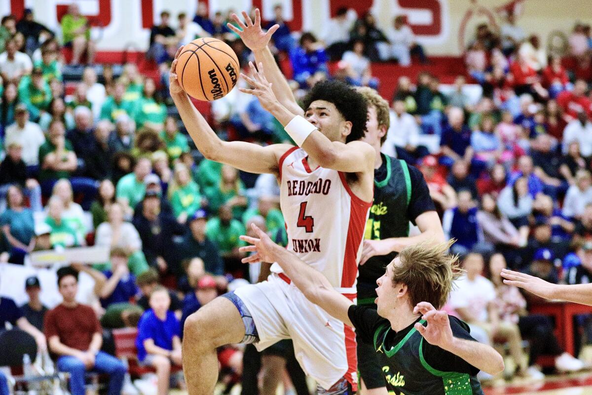 Devin Wright drives to the basket during his 23-point effort against Mira Costa on Friday.