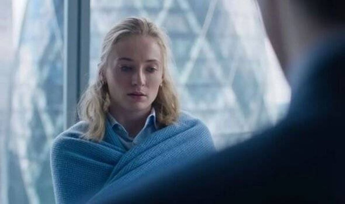 A woman looks scared as she's wrapped in a blanket