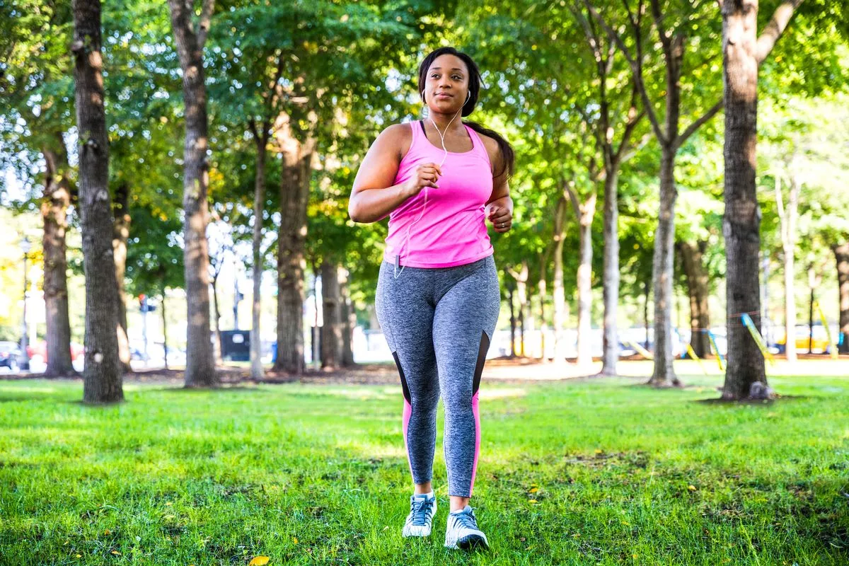 Plus size women jogging and exercising at the park