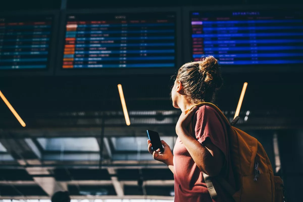 Woman checks airline schedule at airport